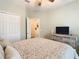 This bedroom features a double closet, ensuite access, and fan at 501 Heartwell Dr, Poinciana, FL 34759