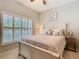 This bedroom features a light color palette and a sunny window at 501 Heartwell Dr, Poinciana, FL 34759