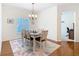 Bright dining room with a chandelier, seating for six, and a view of the living area at 501 Heartwell Dr, Poinciana, FL 34759
