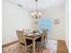 Bright dining room features a chandelier and wood floors with a decorative area rug at 501 Heartwell Dr, Poinciana, FL 34759