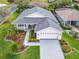 Stunning single-story home boasts a beautifully landscaped front yard and a welcoming entrance at 501 Heartwell Dr, Poinciana, FL 34759