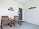 Relaxing front porch with rocking chairs, a welcome sign, and a charming wreath on the front door at 501 Heartwell Dr, Poinciana, FL 34759