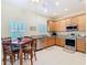 Open kitchen with stainless steel appliances, tile floors, and a breakfast nook at 501 Heartwell Dr, Poinciana, FL 34759