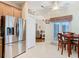 Open kitchen view shows the stainless refrigerator, cabinets, and kitchen nook at 501 Heartwell Dr, Poinciana, FL 34759