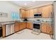 Bright kitchen with stainless steel appliances and tile flooring at 501 Heartwell Dr, Poinciana, FL 34759