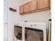 Well-equipped laundry room featuring a washer and dryer, with added storage space at 501 Heartwell Dr, Poinciana, FL 34759