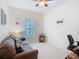 Cozy living room featuring a comfortable couch and a bright window with natural light at 501 Heartwell Dr, Poinciana, FL 34759