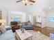 Open living room with hardwood floors, comfortable sofas, and a view of the dining area at 501 Heartwell Dr, Poinciana, FL 34759