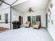 Inviting screened patio with wicker chairs, ceiling fan, and outdoor grill, perfect for entertaining at 501 Heartwell Dr, Poinciana, FL 34759