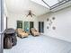 Inviting screened patio with wicker chairs, ceiling fan, and outdoor grill, perfect for entertaining at 501 Heartwell Dr, Poinciana, FL 34759