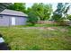Side view of the back yard with the detached garage and wooden fence at 516 W 7Th St, Lakeland, FL 33805