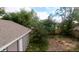 View of the large backyard with a detached garage and mature trees at 516 W 7Th St, Lakeland, FL 33805