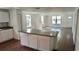 Modern kitchen with granite countertops, white cabinets, stainless appliances and wood floors at 516 W 7Th St, Lakeland, FL 33805