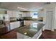 Updated kitchen featuring granite counters, white cabinets, an island with a bar, and stainless appliances at 516 W 7Th St, Lakeland, FL 33805