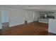 Hardwood floors are featured in this bright and airy living space, with kitchen in the background at 516 W 7Th St, Lakeland, FL 33805