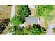 An aerial view of a single-Gathering home surrounded by mature trees and lush landscaping creating a private setting at 5641 Orange Ave, Intercession City, FL 33848