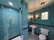 Unique bathroom with teal tiling, a standup shower, and distinctive nautical decor at 5641 Orange Ave, Intercession City, FL 33848