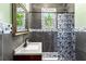 Bathroom with dark wood vanity, shower with patterned curtain, and stylish finishes at 5641 Orange Ave, Intercession City, FL 33848