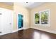 Spacious bedroom with hardwood floors and an ensuite bathroom featuring striking blue tile accents at 5641 Orange Ave, Intercession City, FL 33848