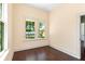 Bright bedroom with dark wood floors and multiple windows, providing natural light and pleasant views at 5641 Orange Ave, Intercession City, FL 33848