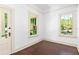 Cozy bedroom featuring wood floors, white walls, and large windows providing a bright and airy feel at 5641 Orange Ave, Intercession City, FL 33848