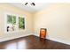 Well-lit bedroom featuring beautiful wood floors, a ceiling fan, and large windows for ample natural light at 5641 Orange Ave, Intercession City, FL 33848