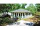 Charming home with a green roof, inviting porch, and well-manicured lawn at 5641 Orange Ave, Intercession City, FL 33848