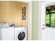 Convenient laundry room with washer and dryer hookups and access to back porch at 5641 Orange Ave, Intercession City, FL 33848
