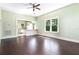 Open living room featuring dark hardwood floors and views of the kitchen at 5641 Orange Ave, Intercession City, FL 33848