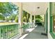 Spacious covered porch with ample seating, perfect for relaxing outdoors and enjoying the neighborhood views at 5641 Orange Ave, Intercession City, FL 33848