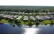 Aerial view of home featuring serene lake and surrounding community at 585 Grand Canal Dr, Poinciana, FL 34759