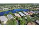Aerial view of the home on the water with mature landscaping at 585 Grand Canal Dr, Poinciana, FL 34759