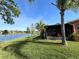 Beautiful backyard view of the water from the lush lawn and screened in porch at 585 Grand Canal Dr, Poinciana, FL 34759