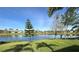 Picturesque backyard with tranquil lake view and lush green landscape at 585 Grand Canal Dr, Poinciana, FL 34759