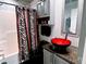 Upgraded bathroom featuring tiled walls, a modern vanity with a red vessel sink and tub at 585 Grand Canal Dr, Poinciana, FL 34759