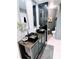 Stylish bathroom with a double sink vanity, decorative mirrors, and a modern toilet at 585 Grand Canal Dr, Poinciana, FL 34759