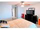 Bright bedroom with a large bed, a dresser, and a comfortable red chair at 585 Grand Canal Dr, Poinciana, FL 34759