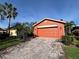 Charming home featuring a well-manicured brick driveway and a two-car garage at 585 Grand Canal Dr, Poinciana, FL 34759
