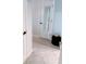 Bright hallway with neutral paint and tile flooring, with doors and decorative mirror at 585 Grand Canal Dr, Poinciana, FL 34759