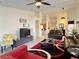 Spacious living room featuring tile flooring, high ceilings, and ample natural light, perfect for entertaining at 585 Grand Canal Dr, Poinciana, FL 34759