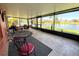 Inviting enclosed patio overlooking a picturesque canal, perfect for relaxing and enjoying outdoor living at 585 Grand Canal Dr, Poinciana, FL 34759