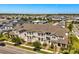 Aerial view of the community with sidewalks, green spaces and various townhome designs at 7063 Nemours Pkwy, Orlando, FL 32827