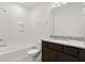 Bathroom with dark wood cabinets, granite countertops, and tiled shower at 7063 Nemours Pkwy, Orlando, FL 32827