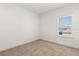 This bedroom offers neutral carpet and a window for natural light at 7063 Nemours Pkwy, Orlando, FL 32827