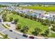 Community green space with a gazebo, walking paths, and lush landscaping near a lake at 7063 Nemours Pkwy, Orlando, FL 32827