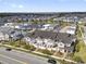 Townhomes featuring white trim and red doors with private balconies overlooking the community at 7063 Nemours Pkwy, Orlando, FL 32827