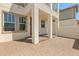 Inviting covered patio with red front door and brick pavers at 7063 Nemours Pkwy, Orlando, FL 32827