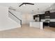 Open-concept living area that flows into a modern kitchen with stainless steel appliances at 7063 Nemours Pkwy, Orlando, FL 32827