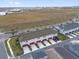 Rear view of townhomes with private garages and parking at 7063 Nemours Pkwy, Orlando, FL 32827