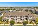 Charming townhomes featuring white trim and red doors with private balconies overlooking the community at 7063 Nemours Pkwy, Orlando, FL 32827
